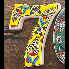 Decorative number '7' with floral patterns on a wooden background